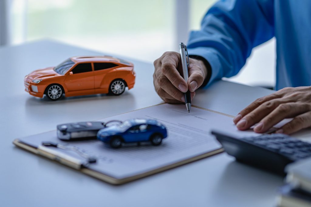 Auto insurance Mesa AZ customer signing a car insurance policy