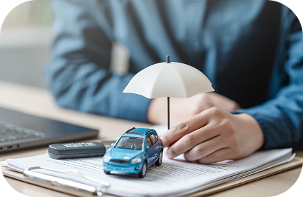 Insurance services Mesa AZ agent reviewing an auto policy with a model car